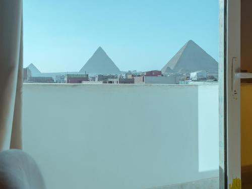 a view of the pyramids from the window of a room at pyramids rose view inn in Cairo