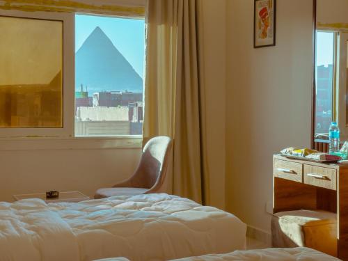 a hotel room with a bed and a window at pyramids rose view inn in Cairo