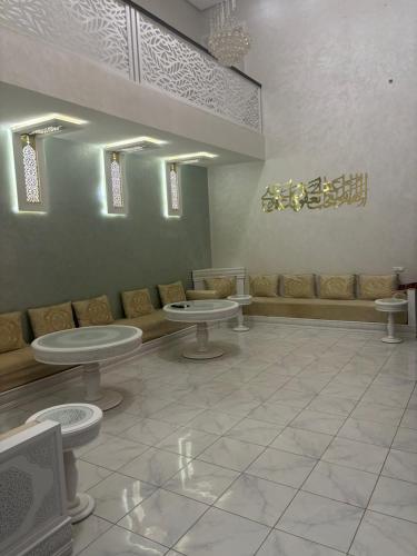 a waiting room with tables and a couch at Villa Jamel Marrakech Zac in Marrakech