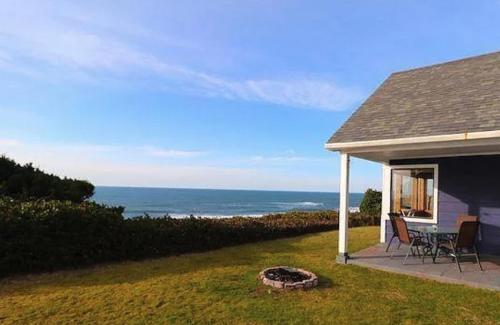 a house with a patio with a table and chairs at Coastal Serenity in Lincoln City