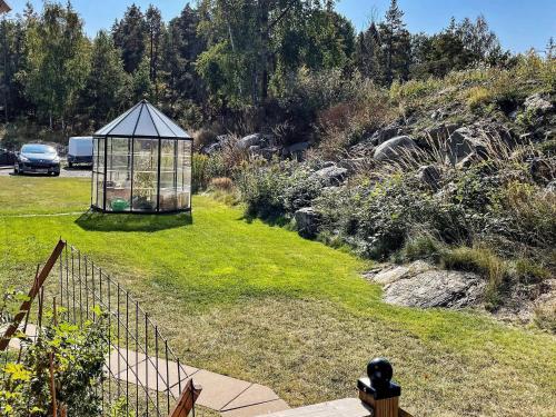 a garden with a gazebo in the grass at 4 person holiday home in HUDDINGE-By Traum in Huddinge