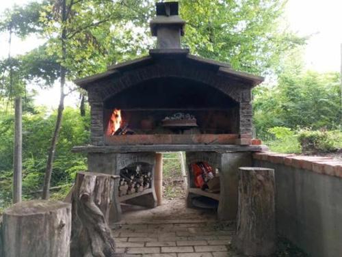 a brick oven with a fire inside of it at Vikendica Novska planina in Rudice