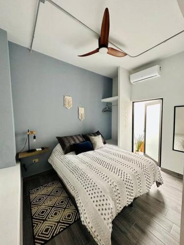 a bedroom with a bed with a ceiling fan at Malecon NEW Casita Victoria in La Paz