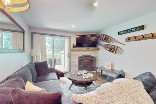 a living room with a couch and a fireplace at Beaver Creek Bungalow in Avon