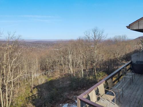 a deck with two chairs and a view of the woods at Pocono Mountain Village at Camelback 294 Overlook Way in Tannersville