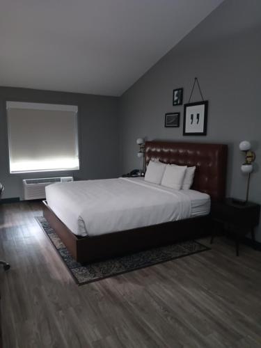 a bedroom with a large bed and a flat screen tv at Four Points by Sheraton Dallas Arlington Entertainment District in Arlington