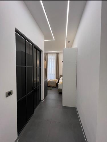 a hallway of a room with white walls and black doors at Luxury Marina apartments in Rijeka