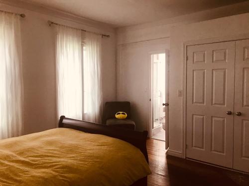 a bedroom with a bed and a window and a door at WHITE SWAN House in Niagara Falls