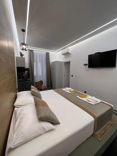 a bedroom with two beds and a flat screen tv at Luxury Marina apartments in Rijeka