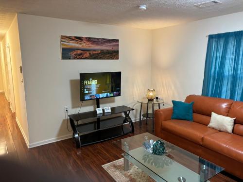 a living room with a couch and a tv at Atlanta Quiet Private Room 2 in Atlanta