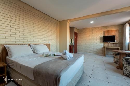 a bedroom with a bed with a stuffed animal on it at Rede Andrade Goiania Centro in Goiânia