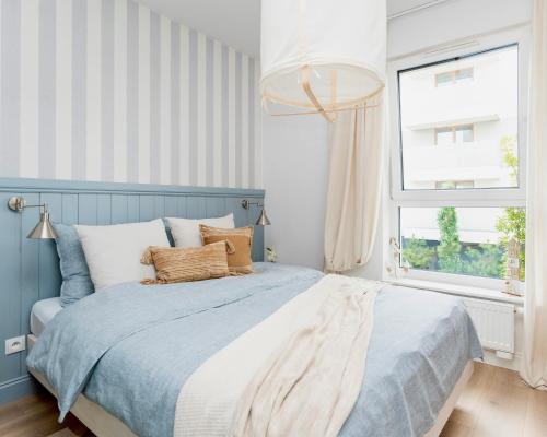 Ένα ή περισσότερα κρεβάτια σε δωμάτιο στο Apartament Aqua Przystań 80 - Rumia Novum