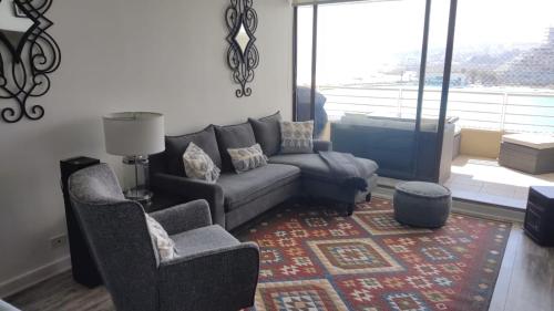 a living room with a couch and two chairs at San Alfonso del Mar Ideal in Mirasol