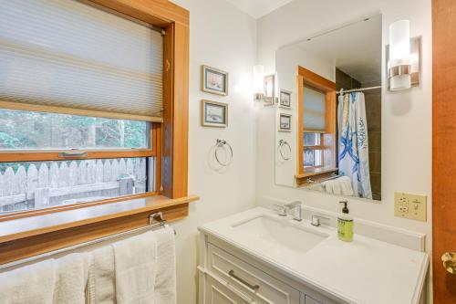 a bathroom with a sink and a mirror and a window at Oceanfront Frenchman Bay Home Stunning View! in Marlboro