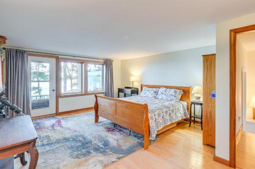 a bedroom with a bed and a desk and windows at Oceanfront Frenchman Bay Home Stunning View! in Marlboro