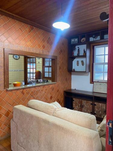 a room with a couch and a table and some windows at Casa do Alferes in Ouro Preto