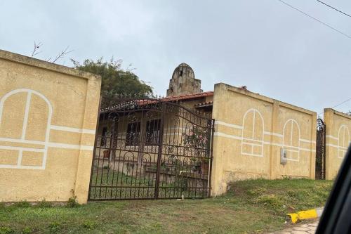 an old building with a gate in front of it at HANZ Samaipata in Samaipata