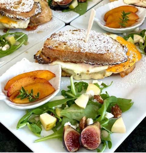 a plate of food with a sandwich and a salad at Domaine Chardonnay in Temecula