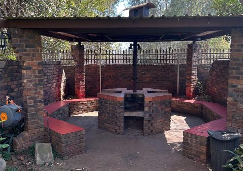 a brick fireplace in a patio with a brick wall at Entire Apartment in Eldoraigne, Centurion in Eldoraigne