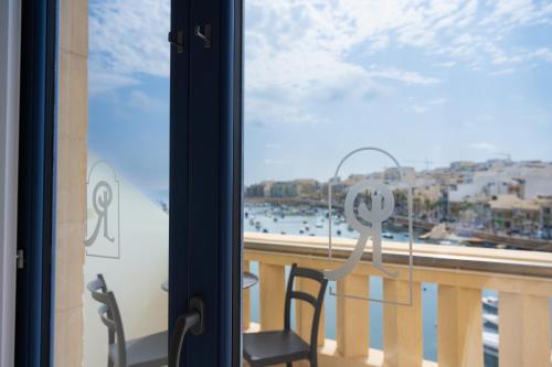 a balcony with a view of the water at Casa Rosanna Malta B&B Adults only 16 plus in Marsaskala