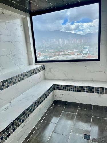 an empty bathroom with a large window in a building at Apartamento exclusivo en Sabaneta, Antioquia in Sabaneta