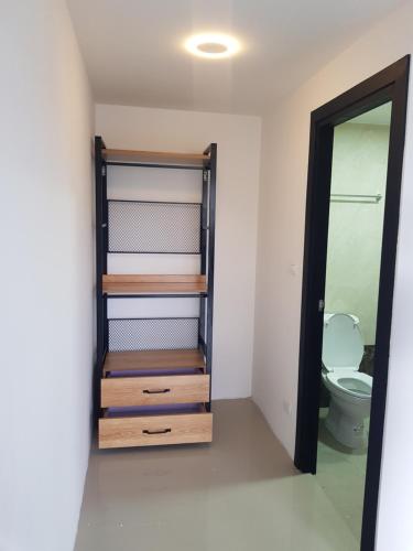 a bathroom with a toilet and a mirror at Rawai beach condominium 拉薇海滩酒店公寓 in Nai Harn Beach