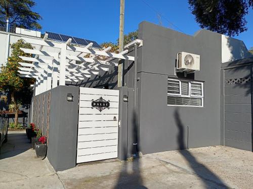 a garage with a white door and a white fence at Dalau on Main in Paarl