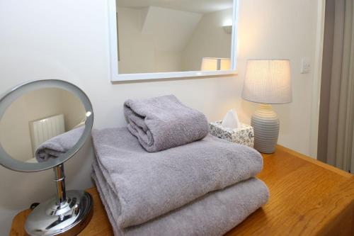 a room with a mirror and a chair on a table at Abbey Foregate in Shrewsbury