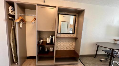 a small room with a mirror and a table at Holiday Inn Rock Springs by IHG in Rock Springs