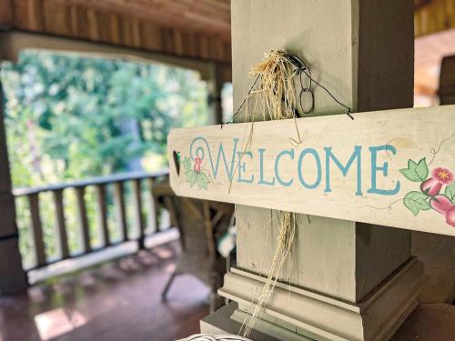 a welcome sign on the side of a porch at Hummingbird Gardens B&B in Ladysmith