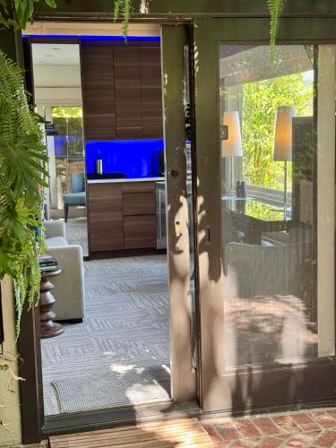 an open door leading to a kitchen and living room at HOLLYWOOD HILLS JETLINER VIEWS at STUDIO 1080 HOLLYWOOD in Los Angeles