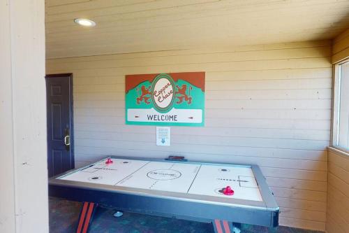 a table in a room with a sign on the wall at President Studio Pool-Spa Ski-in out Gym, Sauna, Laundry, BBQ in Brian Head