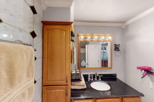 a bathroom with a sink and a mirror at President Studio Pool-Spa Ski-in out Gym, Sauna, Laundry, BBQ in Brian Head