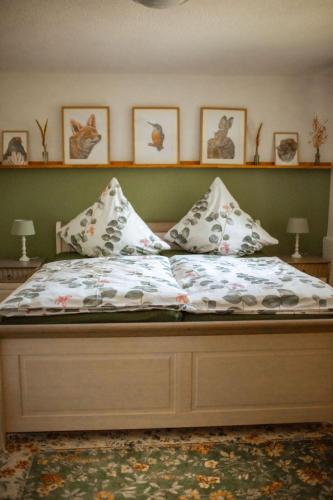a bed with pillows on it in a bedroom at Haus Eickert - Ferienwohnung in Undeloh