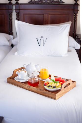 a tray of breakfast food on a bed at Hotel Palacio de Hemingway in Ronda