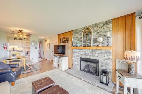 a living room with a stone fireplace at 1 Mi to Ski Lifts Sugar Mountain Condo in Sugar Mountain