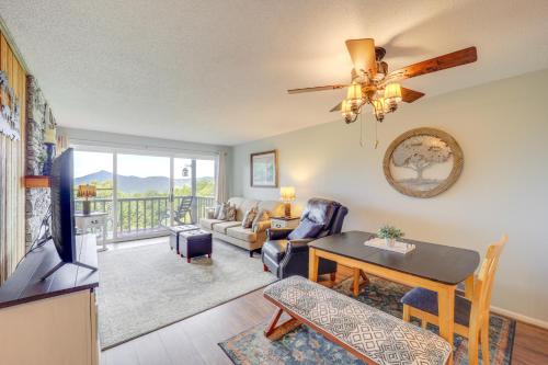 a living room with a couch a table and a ceiling fan at 1 Mi to Ski Lifts Sugar Mountain Condo in Sugar Mountain