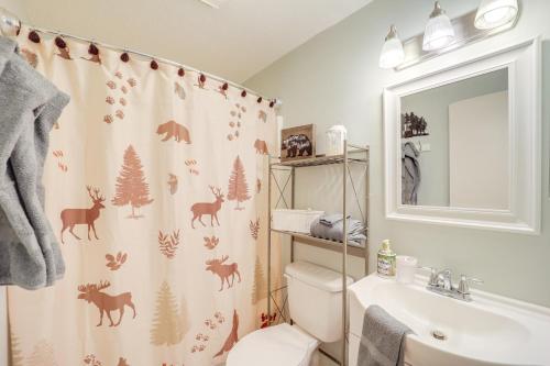 a bathroom with a shower curtain with deer on it at 1 Mi to Ski Lifts Sugar Mountain Condo in Sugar Mountain