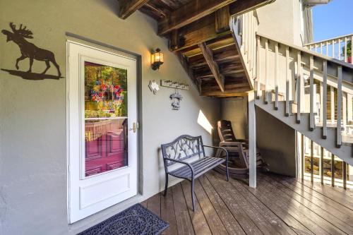 a hallway with a door and a chair and stairs at 1 Mi to Ski Lifts Sugar Mountain Condo in Sugar Mountain