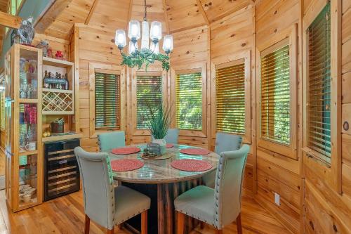 a dining room with a table and chairs at Now and Forever cabin in Sevierville