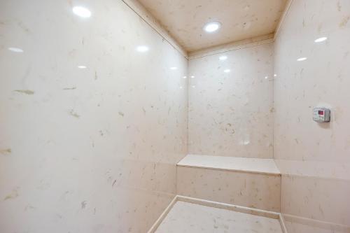 a bathroom with a shower with white walls at Now and Forever cabin in Sevierville