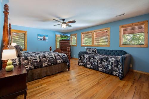 a bedroom with two beds and a ceiling fan at Now and Forever cabin in Sevierville