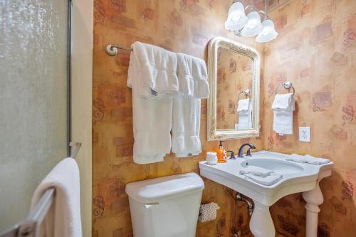 a bathroom with a sink and a toilet and a mirror at Now and Forever cabin in Sevierville