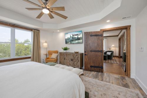a bedroom with a white bed and a large window at 27 South - Large Lux Retreat With Hot Tub & Gameroom in Thompsons Station