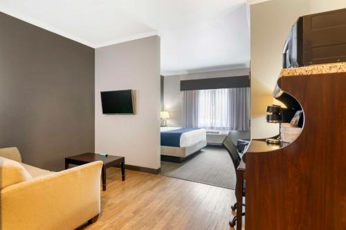 a hotel room with a bedroom and a bed at Best Western Plus Olathe Hotel in Olathe