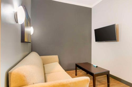 a living room with a couch and a table at Best Western Plus Olathe Hotel in Olathe