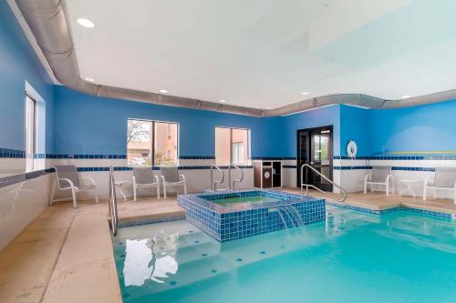 a swimming pool in a room with blue walls at Best Western Plus Olathe Hotel in Olathe