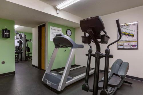 a gym with a treadmill and two exercise bikes at Best Western Plus Scottsdale Thunderbird Suites in Scottsdale