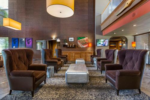 a waiting room with leather chairs and a table at Best Western Plus Scottsdale Thunderbird Suites in Scottsdale