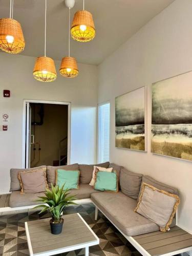 a living room with a couch and a table at Ocean 3 Condo By Abitre Playa Blanca in Río Hato